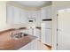 Well-equipped kitchen featuring white cabinetry and a double sink at 1313 Enderbury Dr, Raleigh, NC 27614