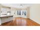 Compact kitchenette with white cabinets, hardwood floors and a breakfast bar at 1313 Enderbury Dr, Raleigh, NC 27614