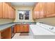 Laundry room features built-in cabinets and a utility sink at 1313 Enderbury Dr, Raleigh, NC 27614