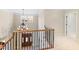 Elegant staircase with wrought-iron railing overlooking the entryway at 1313 Enderbury Dr, Raleigh, NC 27614