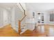 Elegant staircase with hardwood floors and white railing at 1313 Enderbury Dr, Raleigh, NC 27614