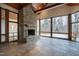 Sunroom with stone fireplace, tile flooring and access to backyard patio at 1313 Enderbury Dr, Raleigh, NC 27614
