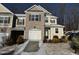 Two-story townhome with brick and siding exterior, attached garage, and snowy landscaping at 133 Walking Path Pl, Hillsborough, NC 27278