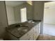 Double vanity bathroom with granite countertop and large mirror at 164 Phil Jack Rd, Dunn, NC 28334