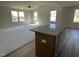 Open living space with high ceiling, neutral carpet and kitchen island at 164 Phil Jack Rd, Dunn, NC 28334