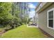 Landscaped backyard with a patio and seating area, surrounded by trees at 172 Cotten Dr, Morrisville, NC 27560