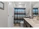 Bathroom with shower/tub combo, vanity, and striped shower curtain at 172 Cotten Dr, Morrisville, NC 27560