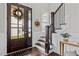 Elegant entryway with dark wood staircase, and decorative wreath at 172 Cotten Dr, Morrisville, NC 27560