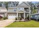 Two story home with stone and shingle accents, two car garage, and landscaped lawn at 172 Cotten Dr, Morrisville, NC 27560