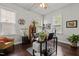 Home office with hardwood floors, large desk, and built in shelving at 172 Cotten Dr, Morrisville, NC 27560