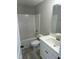 Clean bathroom featuring a tub-shower combo, white tile, and a single sink vanity at 185 N Movado Trl, Kenly, NC 27542