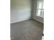 Bedroom with plush carpeting and natural light from a window, ready for personalization at 185 N Movado Trl, Kenly, NC 27542