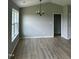 Vaulted ceilings in the dining room with hardwood floors and modern light fixture at 185 N Movado Trl, Kenly, NC 27542