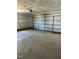 Spacious garage featuring ample room for parking and storage, with an automatic door and concrete flooring at 185 N Movado Trl, Kenly, NC 27542