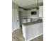 Modern kitchen featuring white cabinets, granite countertops, and stainless steel appliances at 185 N Movado Trl, Kenly, NC 27542