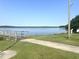 Scenic lake view with a pier and clear blue sky, offering a peaceful waterfront experience at 185 N Movado Trl, Kenly, NC 27542