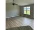 Bright living room featuring hardwood floors and a ceiling fan for comfortable living at 185 N Movado Trl, Kenly, NC 27542
