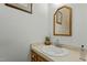 Neutral bathroom features wood framed mirror, artwork and plant for decor at 1909 Pearces Rd, Zebulon, NC 27597
