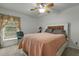 Bedroom features ceiling fan, bed, window with curtains and area rug at 1909 Pearces Rd, Zebulon, NC 27597
