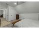 Sloped ceiling bedroom features ceiling fan, storage closet and carpet at 1909 Pearces Rd, Zebulon, NC 27597