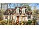 Charming two-story home with red shutters and a welcoming front porch, surrounded by lush landscaping at 1909 Pearces Rd, Zebulon, NC 27597