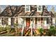 Cozy front porch with white railings and rocking chairs, and a red front door at 1909 Pearces Rd, Zebulon, NC 27597