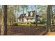 Charming front view of the home with dormer windows and mature trees at 1909 Pearces Rd, Zebulon, NC 27597