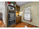 Kitchen area featuring stainless steel appliances including microwave, oven, cooktop, and hardwood flooring at 1909 Pearces Rd, Zebulon, NC 27597