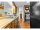 Kitchen featuring wooden cabinets, stainless steel appliances, wood floors, and a pass-through at 1909 Pearces Rd, Zebulon, NC 27597