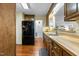 Kitchen with wooden cabinets, wood floors, stainless appliances, and view to front of home at 1909 Pearces Rd, Zebulon, NC 27597