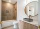 Modern bathroom with tub, floating vanity, and gray tile at 2011 Angier Ave, Durham, NC 27703