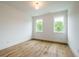 Simple bedroom with hardwood floors and two windows at 2011 Angier Ave, Durham, NC 27703