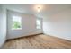 Simple bedroom with hardwood floors and two windows at 2011 Angier Ave, Durham, NC 27703