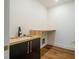 Bright laundry room with modern sink, cabinetry, and workspace at 2011 Angier Ave, Durham, NC 27703