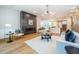 Open living room with a modern fireplace, hardwood floors, and kitchen view at 2011 Angier Ave, Durham, NC 27703