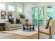 Light-filled living room featuring a comfortable sofa and large windows at 2011 Angier Ave, Durham, NC 27703