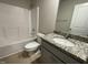 Clean bathroom with granite countertop and a bathtub shower combo at 209 Constellation Ct, Benson, NC 27504