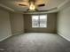 Spacious Primary bedroom with ceiling fan and large window at 209 Constellation Ct, Benson, NC 27504