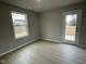 Bright bedroom with wood-look flooring and access to a deck at 209 Constellation Ct, Benson, NC 27504