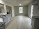 Open dining area with wood-look floors and access to a deck at 209 Constellation Ct, Benson, NC 27504