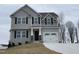 Two-story house with gray siding, black windows, and a two-car garage at 209 Constellation Ct, Benson, NC 27504