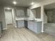 Modern kitchen with gray cabinets, granite countertops, and a tile backsplash at 209 Constellation Ct, Benson, NC 27504