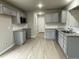 Modern kitchen with gray cabinets, granite countertops, and a tile backsplash at 209 Constellation Ct, Benson, NC 27504