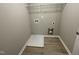 Laundry room with built-in shelving and vinyl flooring at 209 Constellation Ct, Benson, NC 27504