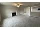 Spacious living room featuring a fireplace and carpet flooring at 209 Constellation Ct, Benson, NC 27504