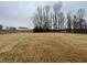 Cleared lot ready for new construction, surrounded by trees at 209 Constellation Ct, Benson, NC 27504