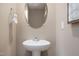 Small bathroom with pedestal sink and oval mirror at 2184 Monk Dr, Haw River, NC 27258