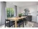 Bright dining room with wood table and six black chairs at 2184 Monk Dr, Haw River, NC 27258