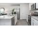 White kitchen cabinets, granite countertops and stainless steel appliances at 2184 Monk Dr, Haw River, NC 27258