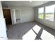 Neutral bedroom with gray carpet, two windows, and white doors at 25 Calabria Ct, Franklinton, NC 27525